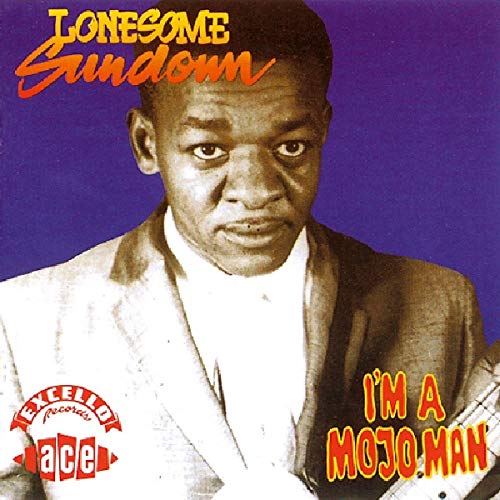 Album cover with man in suit against purple background, holding guitar.