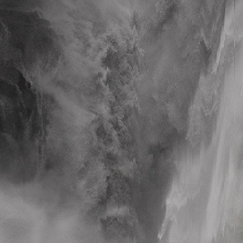Black and white abstract image of icy mountains and swirling mist.