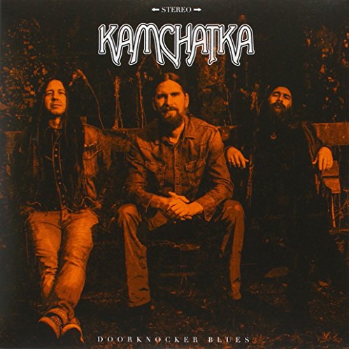 Vinyl record cover with three men sitting on a bench in a forest.