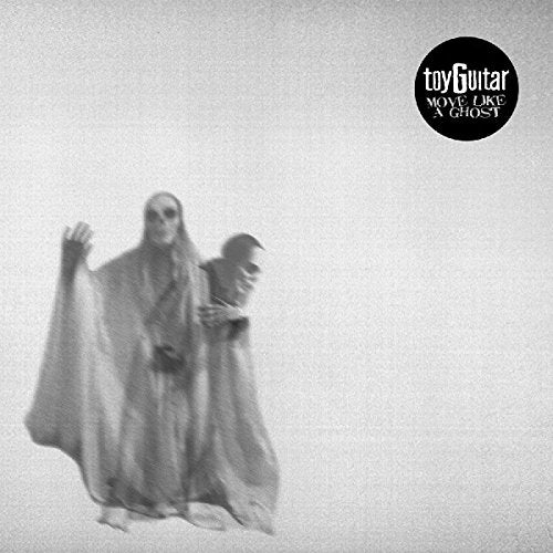 Black and white photo of two figures draped in fabric.