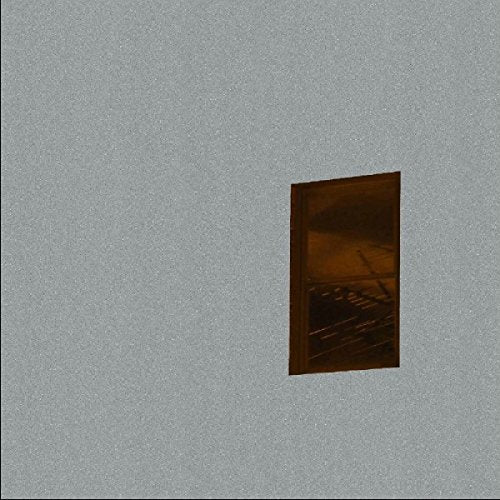 The image shows a vinyl record sleeve on a grey background. Alt text: A vinyl record sleeve with a dark, abstract design on a grey background.