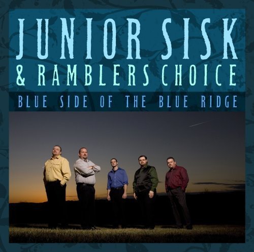 "Album cover with five men standing in a field at dusk, blue and orange sky."