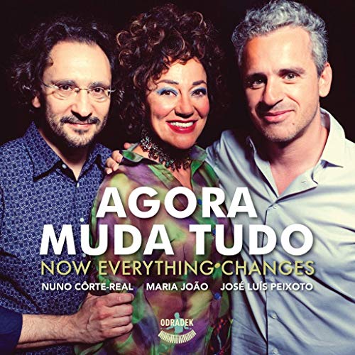 "CD cover featuring three people posing together against a dark background."