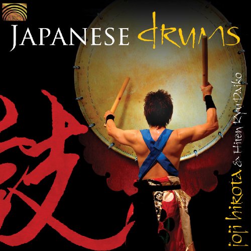 "CD cover featuring a man playing a large drum with drumsticks, against a black background."