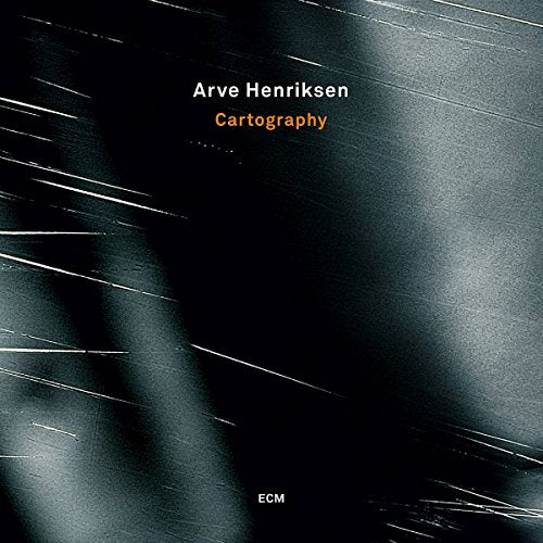 "Album cover with dark background, white and orange text, and abstract white streaks."
