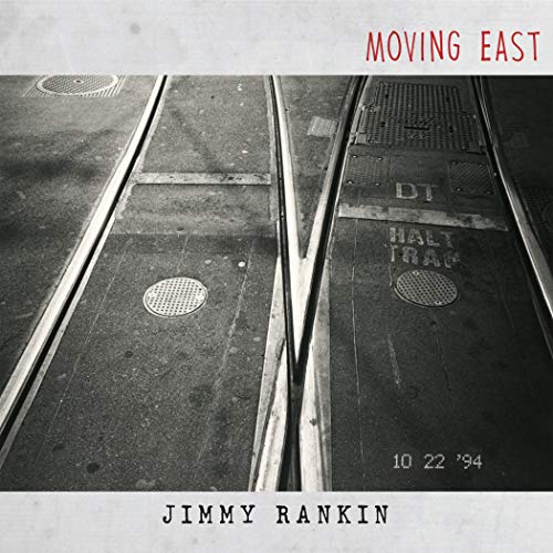 "Album cover with black and white train tracks and 'Moving East' in red text."