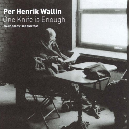 Black and white CD cover featuring a man sitting at a table with sheet music.