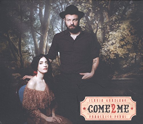 Album cover with man and woman in a forest, decorative title at the bottom right.