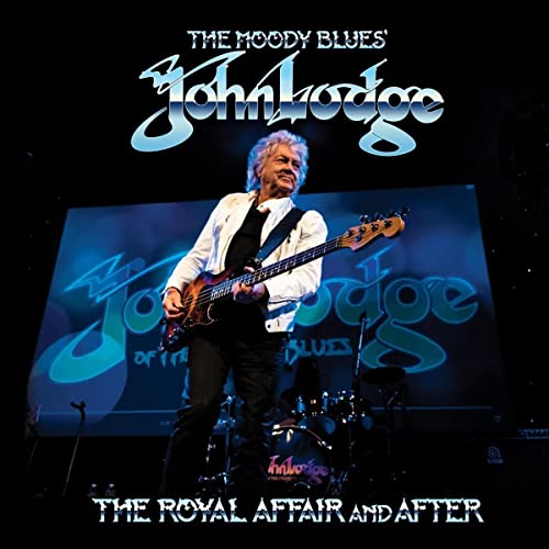 John Lodge of The Moody Blues playing a bass guitar onstage.