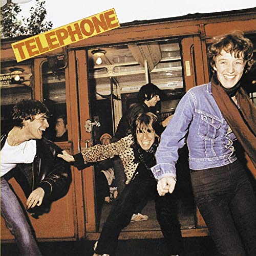 Album cover for Telephone's first album, featuring a band entering a train.