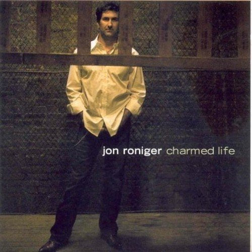 Album cover of Jon Roniger's "Charmed Life" showing a man standing behind a railing.