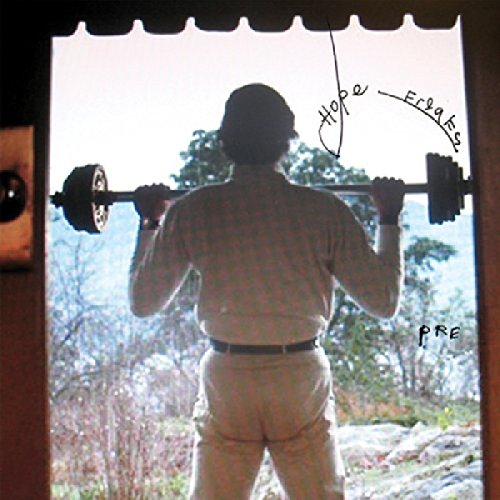 The alt text for the image is: "Man lifting weights outdoors, viewed from behind through a doorway."