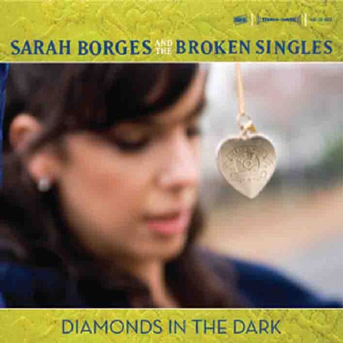 "Album cover with a woman and a heart-shaped locket on a string."