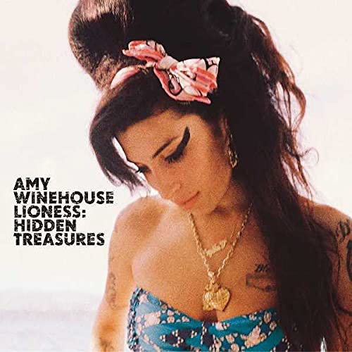 Amy Winehouse wearing a patterned hair bow and gold necklace on album cover art.