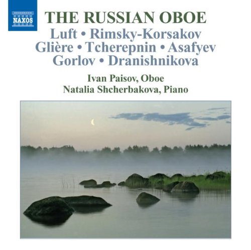 A serene lake scene with rocks and a crescent moon on a CD cover.