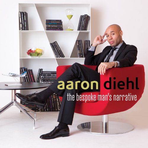 Man in a suit sits in a red chair, album cover art.