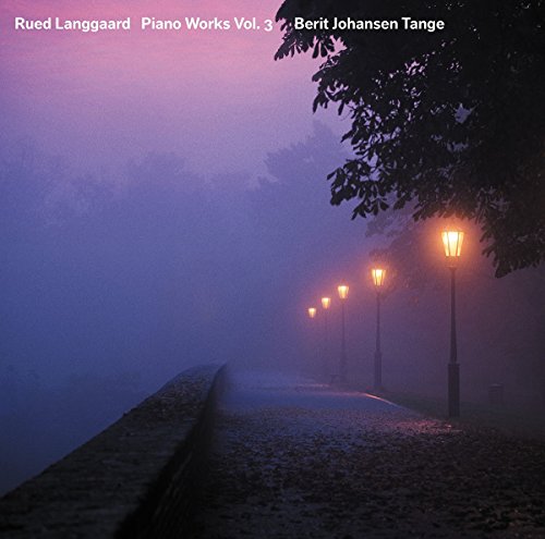 "CD cover with foggy street scene and lit street lamps."
