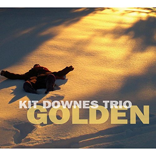 "Album cover with a person lying in snow, 'Kit Downes Trio Golden' text overlay."