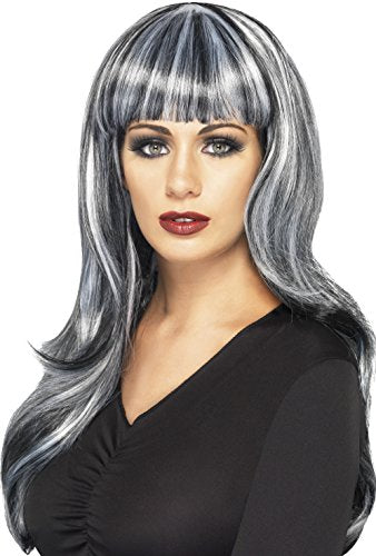 Woman wearing long, wavy black and grey wig with fringe, against a white background.