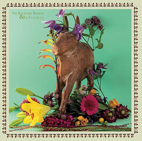 Vinyl album cover featuring a carved donkey adorned with colorful flowers.