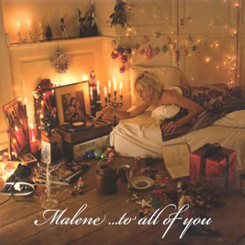 CD cover: woman on bed amidst gifts, candles, and festive decorations.