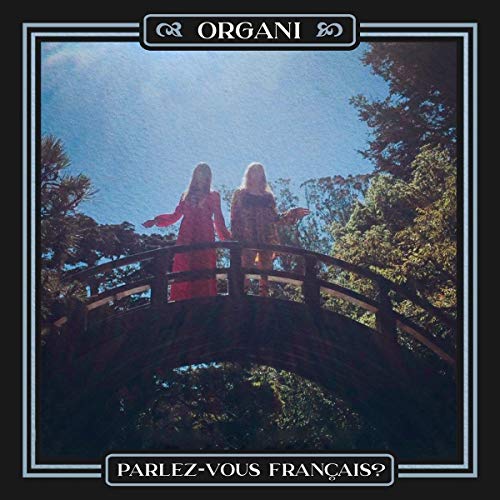 Vinyl album cover: two figures on a bridge, trees, blue sky.