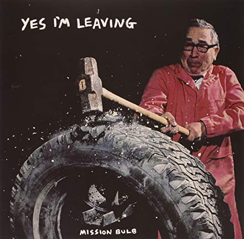 Album cover: man in red smashing a tire with a hammer.