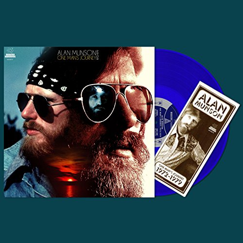 "Blue vinyl record with album cover featuring a man's face and sunglasses."