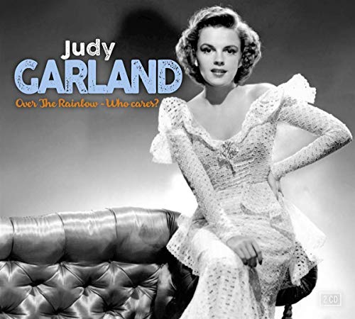 "Black and white CD cover featuring Judy Garland in a white dress on a leather couch."