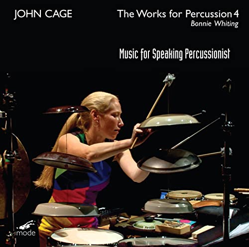 Percussionist Bonnie Whiting playing cymbals amidst a complex drum set.