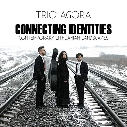 "CD cover featuring three musicians standing on train tracks in a snowy landscape."
