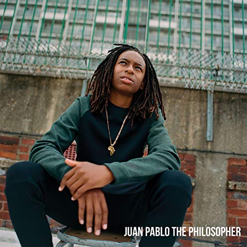 Album cover featuring a man sitting on a stool, wearing dark green attire.