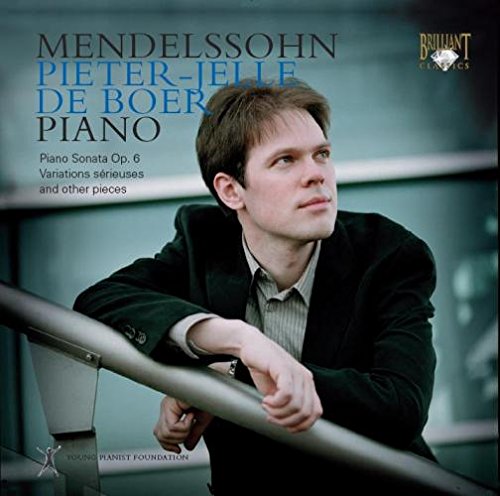 "CD cover with a man in a suit leaning on a railing."