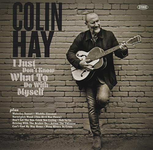CD cover featuring Colin Hay with a guitar, sepia tone, brick wall.