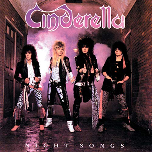 Four band members with teased hair stand in a brick alleyway on this album cover.
