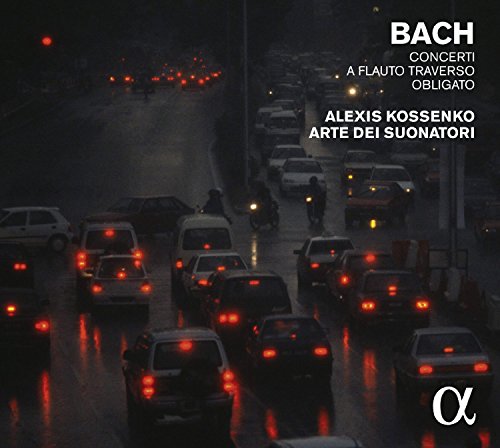 "CD cover featuring a dark, rainy road with cars and red brake lights."