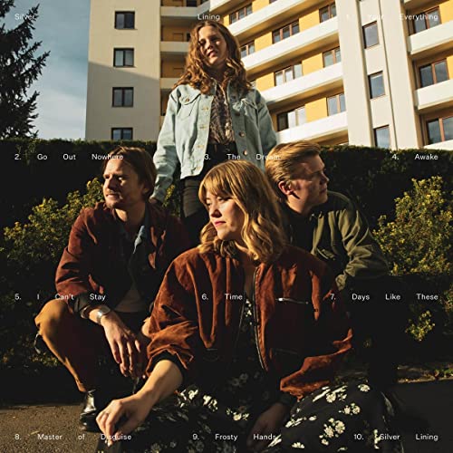 Album cover for “Go Out Nowhere” featuring four people in front of a building.