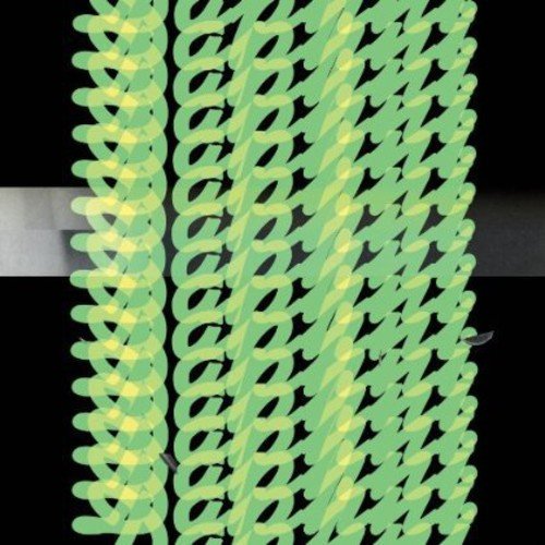 A close-up of a green spiral-shaped object against a black background.
