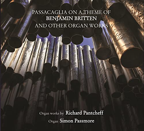 CD cover featuring a low-angle view of silver organ pipes.