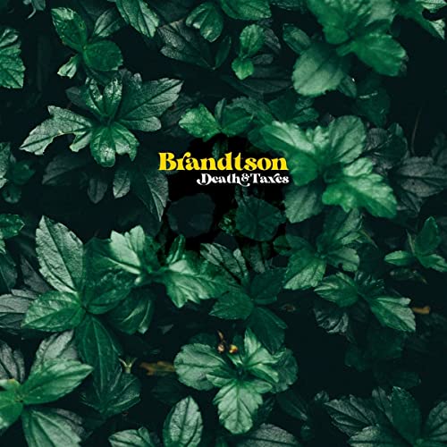 Album cover for Brandtson's "Death & Taxes" featuring lush green foliage.
