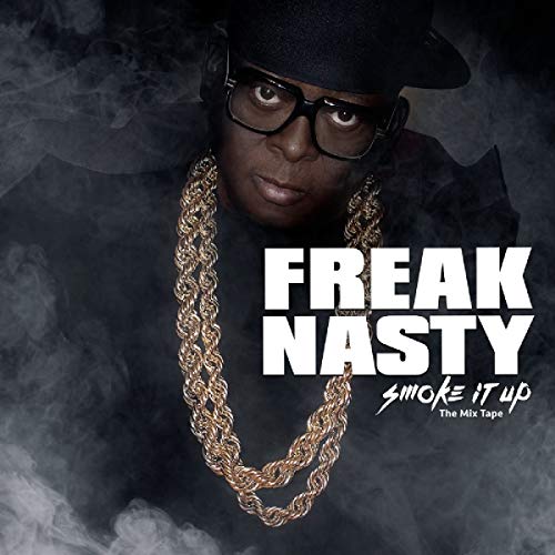 Man wearing black hat and glasses, with gold chain, surrounded by smoke.