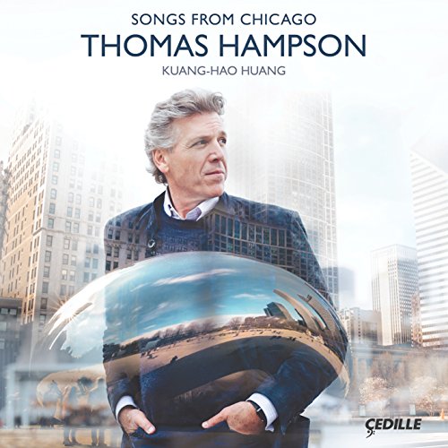 "Album cover featuring a man holding a reflective sphere with a cityscape."