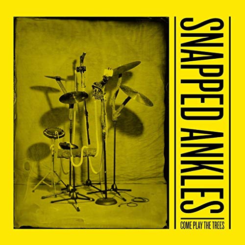 Yellow album cover featuring a chaotic arrangement of drum kit parts.