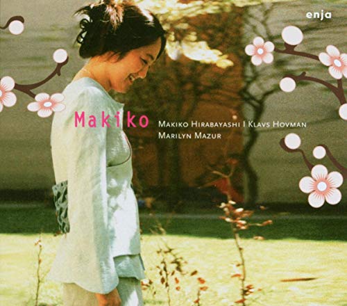 CD cover featuring a woman in a light jacket, with cherry blossom branches.