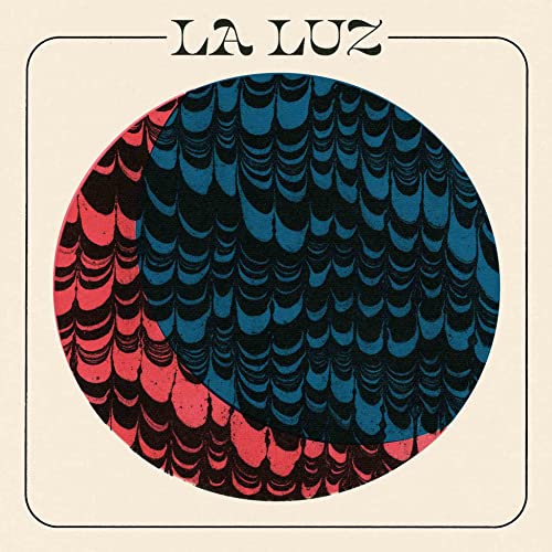 Album cover for La Luz, featuring a red and blue marbled circle.