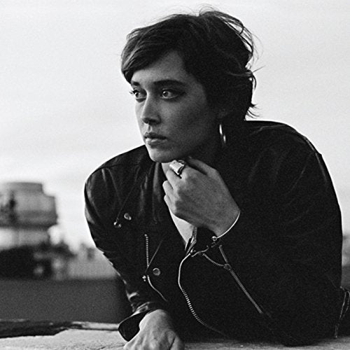 Black and white portrait of a person with short hair wearing a jacket.