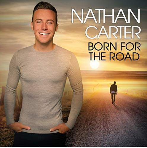 "Album cover featuring Nathan Carter with a man walking down a road at sunset."