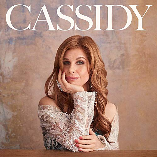 The alt text for the image is: "Cassidy Janson's album cover featuring a woman with red hair."