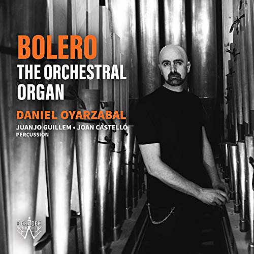 CD album cover featuring a man standing between large metal organ pipes.