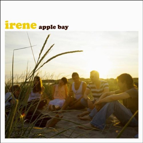 The alt text for the image is: "Album cover featuring a group of people sitting on a beach."